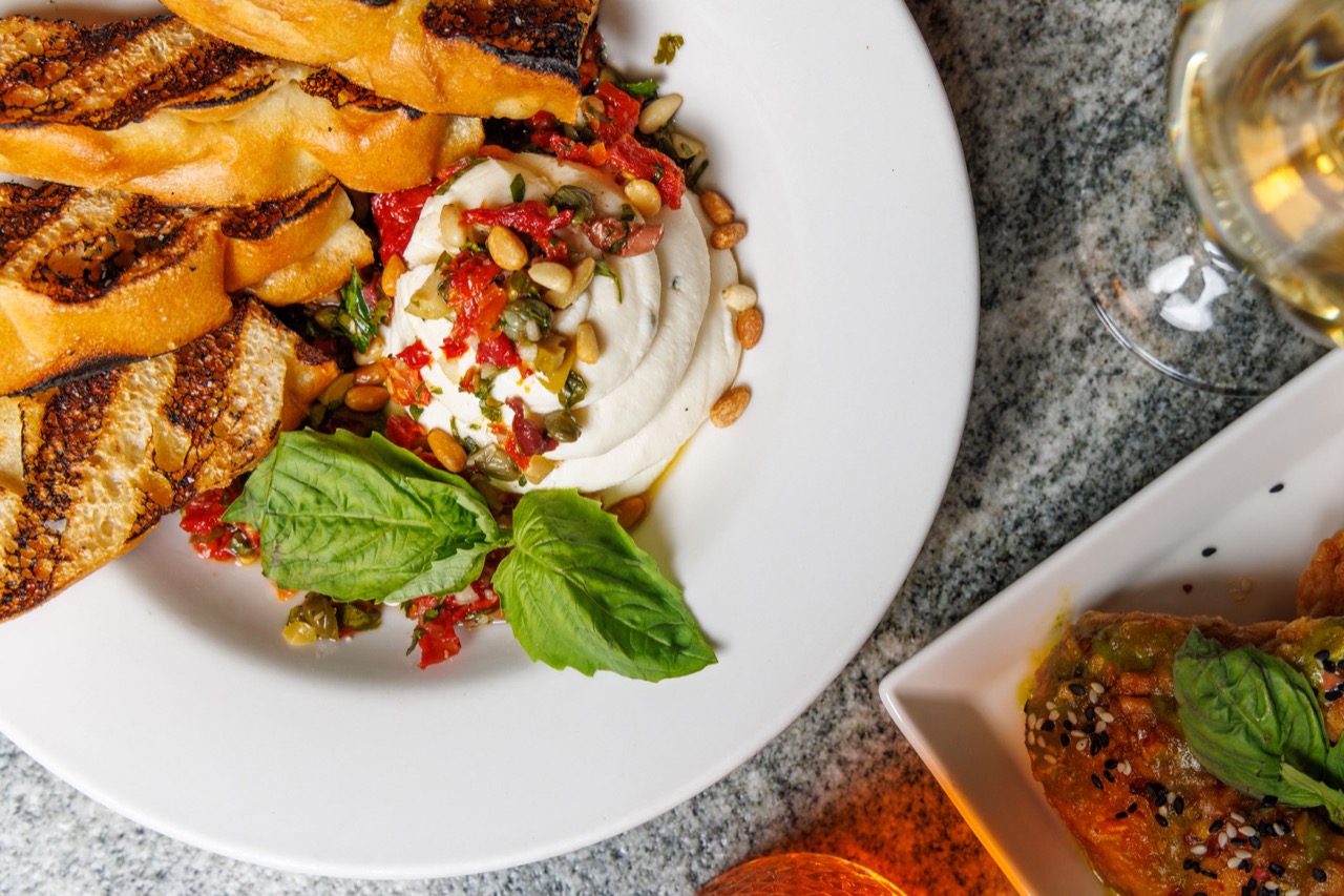Burrata with pine nuts, basil, and grilled bread