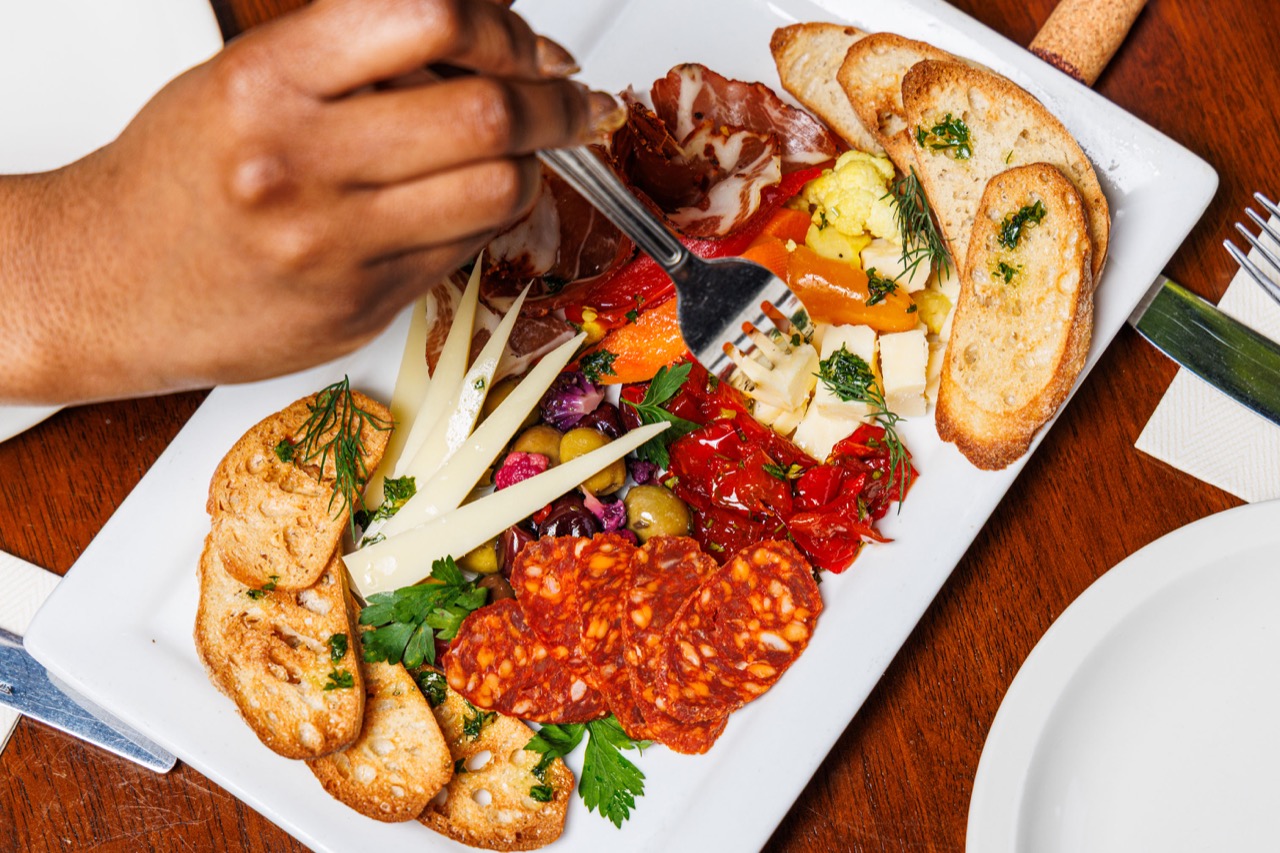 Charcuterie board with cured meats, cheeses, and crostini