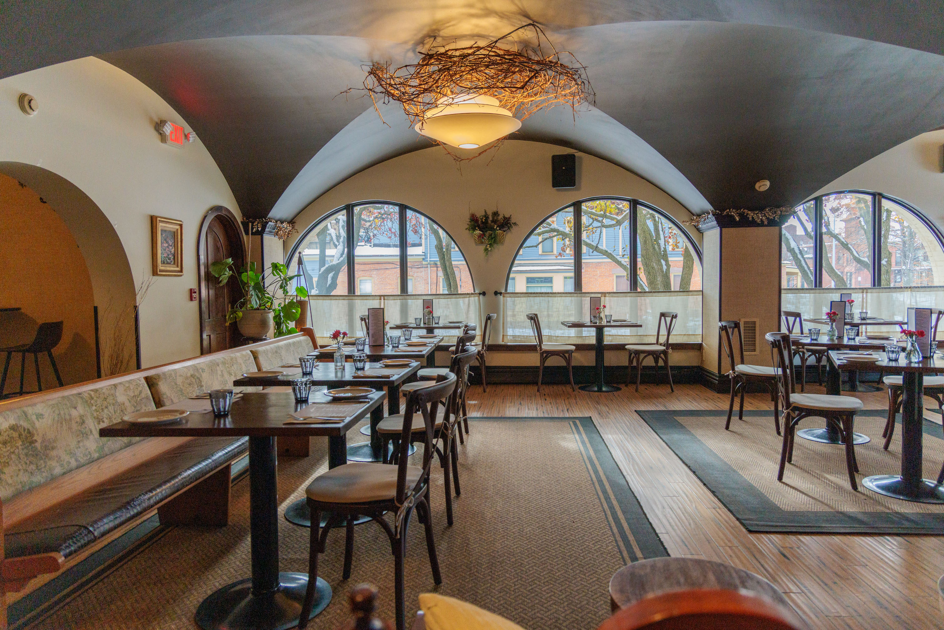 The Alexander dining room with arched windows and banquette seating