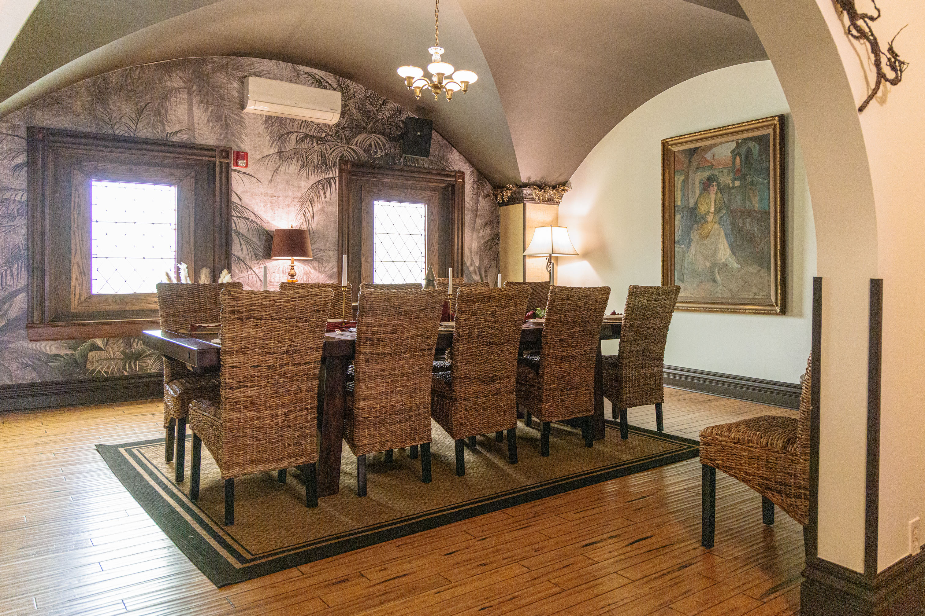The Turret Room with wicker chairs and tropical wallpaper