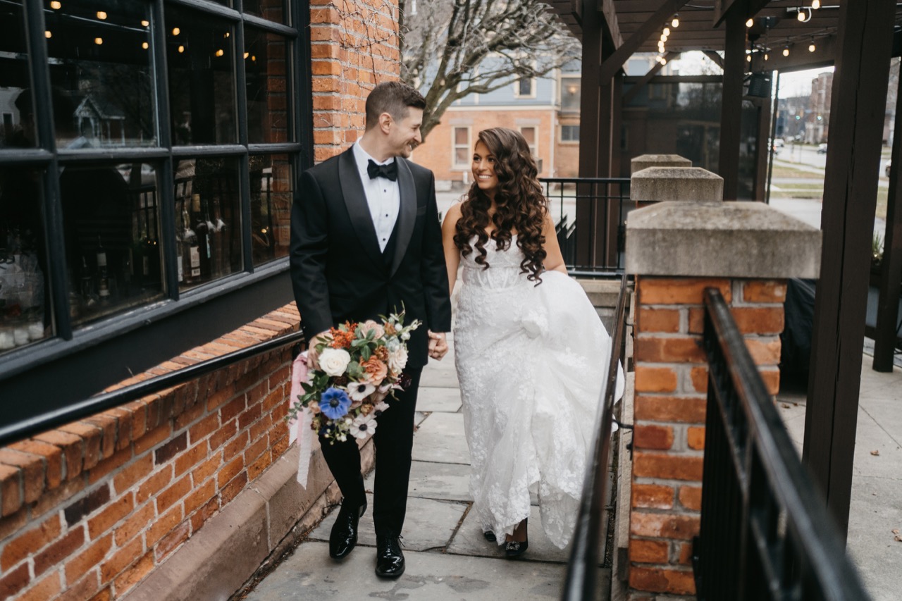 Bride and groom walking outside The Alexander